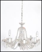 A vintage 20th century glass eight sconce chandelier having eight branches adorned with multiple