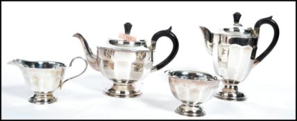 A four piece matching silver plated mid 20th century tea service to include teapot, water pot, sugar