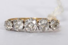 An 18ct gold and platinum, diamond 5 stone ladies ring. 5 claw mounted diamonds on a vintage