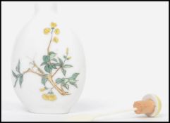 A 19th century Oriental ceramic scent perfume bottle having a white ground with painted floral