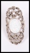 A large silver and marcasite art deco style ring having a large central opal stone, weighs 10