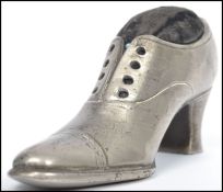 A large early 20th century Edwardian silver white metal novelty pin cushion in the form a ladies