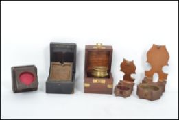 A collection of pocket watch stands to include treen examples, Victorian flip out inlaid ebonised