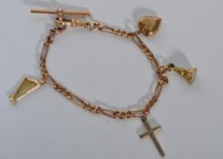 A 9ct gold watch Figaro chain charm bracelet with additional charms not marked. Chain marked 375,