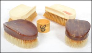 A pair of heavy 19th century ivory brushes bearing monograms along with a pair of faux tortoise