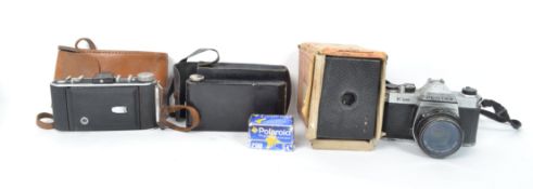 A collection of vintage 20th century cameras to include a boxed brownie, two vintage fold out
