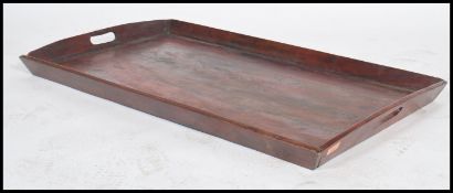 A very large 19th century Victorian butlers tray having a raised edge with pierced handles.