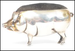 An Edwardian silver hallmarked novelty pin cushion by Adie and Lovekin in the form of a pig with