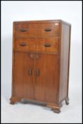 A vintage early 20th century Art Deco oak tall boy rasied on shaped feet with two drawers over