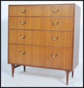 A vintage 20th century Danish influence retro teak 2 over 3 chest of drawers raised on ebonised