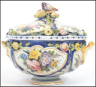 A stunning lidded twin handled Faience tureen / dish, each panel decorated with hand painted fauna