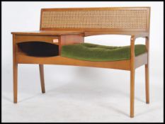 A retro 1970's teak wood telephone table / seat by Mr Chippy, rattan weave style back, button back