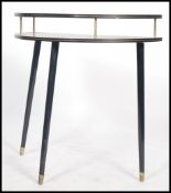 A 1970's retro demi loom side / hall table raised on tapering ebonised legs with half moon top and