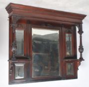 An early 20th Edwardian century over mantle mirror having carved columns with wooden surround.