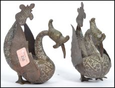A pair of 20th century Indian brass roupese cast fantastical creatures heavily detailed with