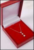 A 14ct white gold graduated diamond necklace of approx 45 points, complete in presentation case.