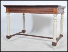 A  19th centuryFrench oak extending shabby chic painted country dining table . Raised on turned legs