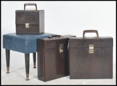A group of vintage 20th century retro vinyl record cases having a crocodile skin effect look along