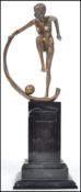 A 20th century Art Deco style bronze effect erotic figurine with cape and ball mounted on a faux