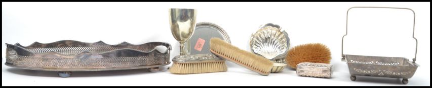 A collection of silver plated wares to include a matching four piece dressing table set, trays etc