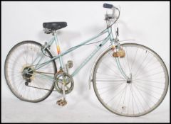 A retro ladies ten speed French bicycle, dating to the 1970's, gear levers to the handle bars and