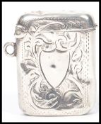 A silver hallmarked vesta match case having a chase decorated with floral swirls and a plain
