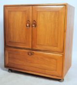 An Ercol 20th century light elm wood ' Windsor ' pattern serving / entertainment cabinet - cupboard.