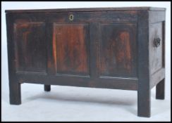 A large 18th century country oak coffer - blanket box chest being raised on tall stile supports with