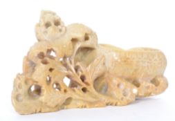 A 20th century Oriental Chinese carved soapstone brush washer with pierced foliage decoration.