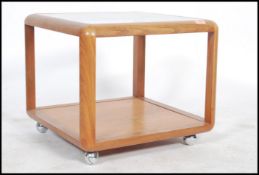 A good vintage G-Plan teak wood coffee table  of square form with drop centre glass top over lower
