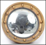 A vintage 20th century gilt wood framed circular convex fish eye wall mirror with ball applied