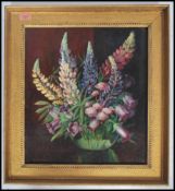 A framed oil on canvas painting still life study of a vase of flowers signed to the corner Ethel