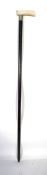 An ivory handled silver collared walking stick cane having a tapering ebonised shaft with shaped