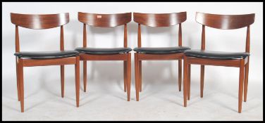 A 1970's retro G-Plan teak wood set of 4 dining chairs  by Kofod Larsen. The chairs raised on
