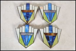 A set of four vintage 20th century Art Deco style stained glass panelled light fixture wall