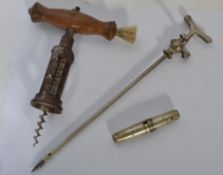 A group of three early 20th century cork screws (corkscrews) to include a tall champagne tap, a