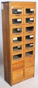 An early 20th century Industrial haberdasher's - shop cabinet of upright pedestal form with multiple