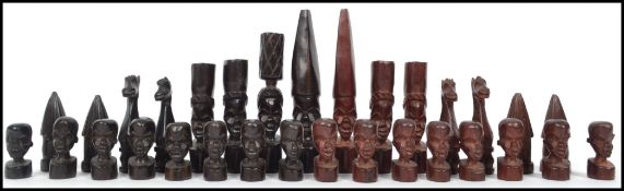 A vintage 20th century African tribal hardwood carved Chess set ( loose in bag ) The pieces being of