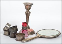 A collection of silver items to include a cranberry glass silver collared scent bottle, napkin