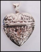 A silver white metal heart shaped vesta case with bail loop atop, weighs 14.3 grams.