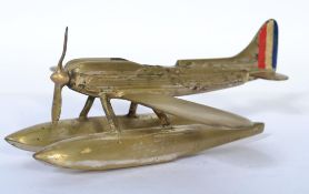 A vintage 20th century brass table lighter in the form of a floating sea areoplane, possibly of a