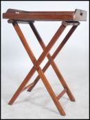 A 19th century Georgian Mahogany butlers tray with raised sides and pierced handle on a