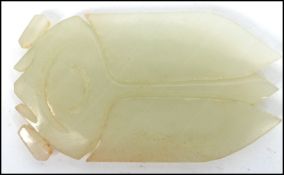 An unusual Chinese carved white/ light green jade pendant in the form of a cricket. Measures 7 cm