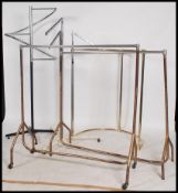 A good collection of 20th century haberdashery shop clothes rails of varying designs to include
