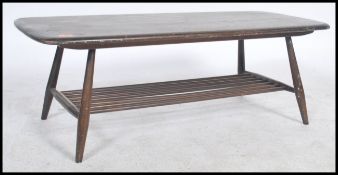 A vintage retro 20th century Ercol gold label low coffee table having a rail bottom raised on