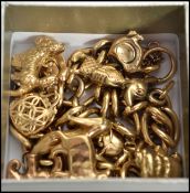 A hallmarked 9ct gold charm bracelet having a heart locket clasp to include many gold charms such as