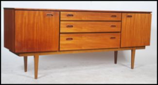 A good 1970's teak wood sideboard of Danish influence raised on tapering legs with a series of