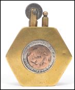 A 20th century trench art military lighter of hexagonal form having an inset British and French coin
