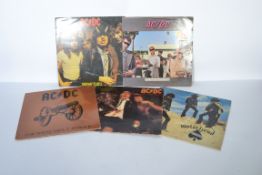 A collection of five vintage long play LP vinyl record rock albums to include AC/DC x four records