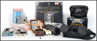 A Vintage Konica SLR Camera together with a hardback copy of the 1952 - 2002 Golden Jubilee, zoom